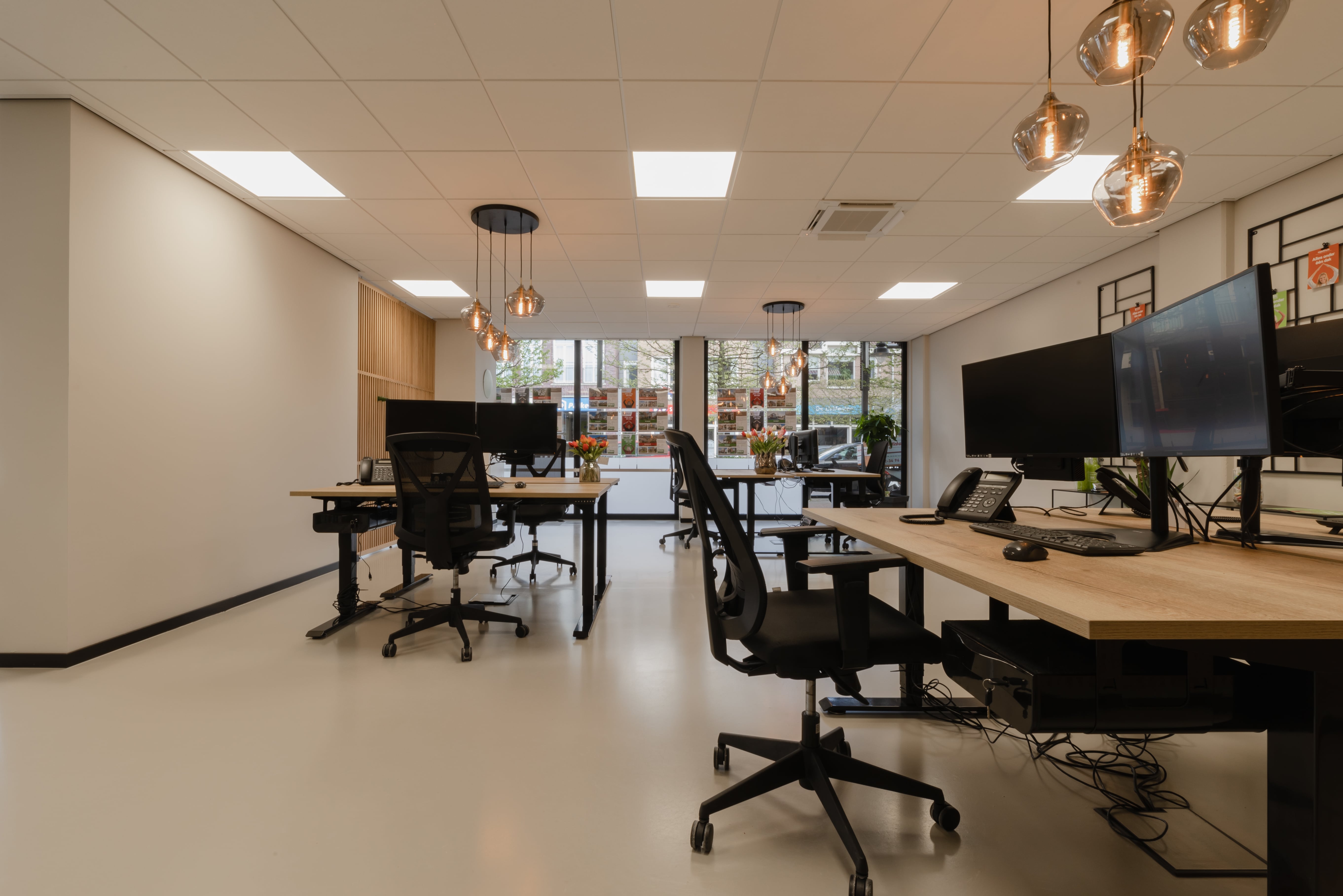 XL houten scheidingswand in een kantoor zorgt voor een elegante verdeling van werkruimtes, biedt privacy en behoudt een open, lichte sfeer in de ruimte.